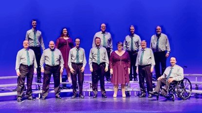 Legacy of Harmony members performing on stage.