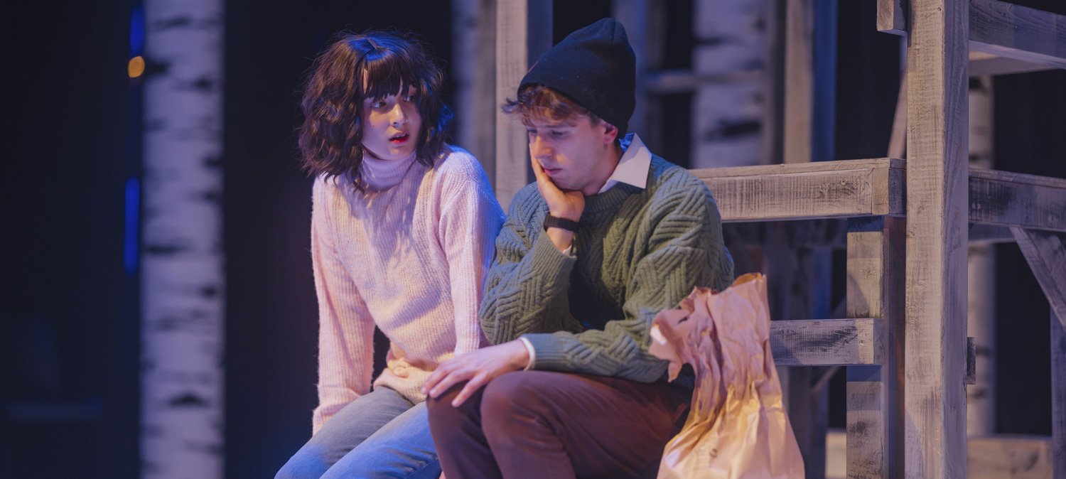 Actors in costume performing on stage.