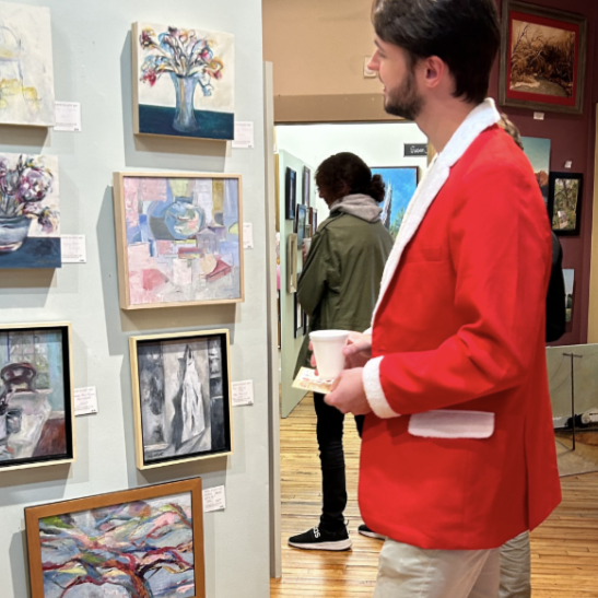 A visitor to the studio gallery viewing artwork.