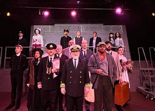 Cast members in costume on stage.