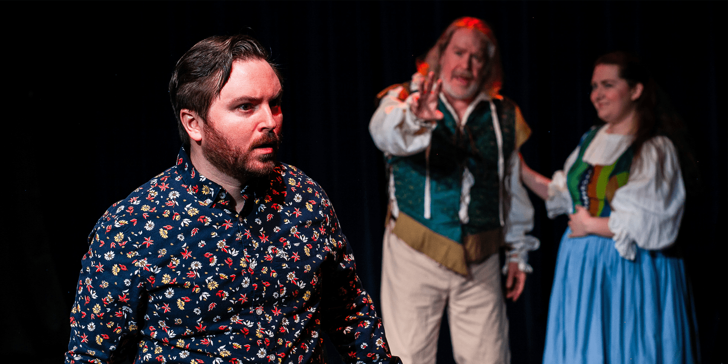 Actors in character performing on stage.